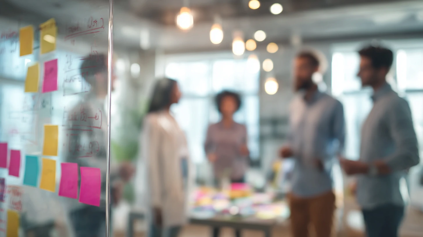 Veterinary leadership team standing around a glass board with a quarterly roadmap for improving their veterinary software stack