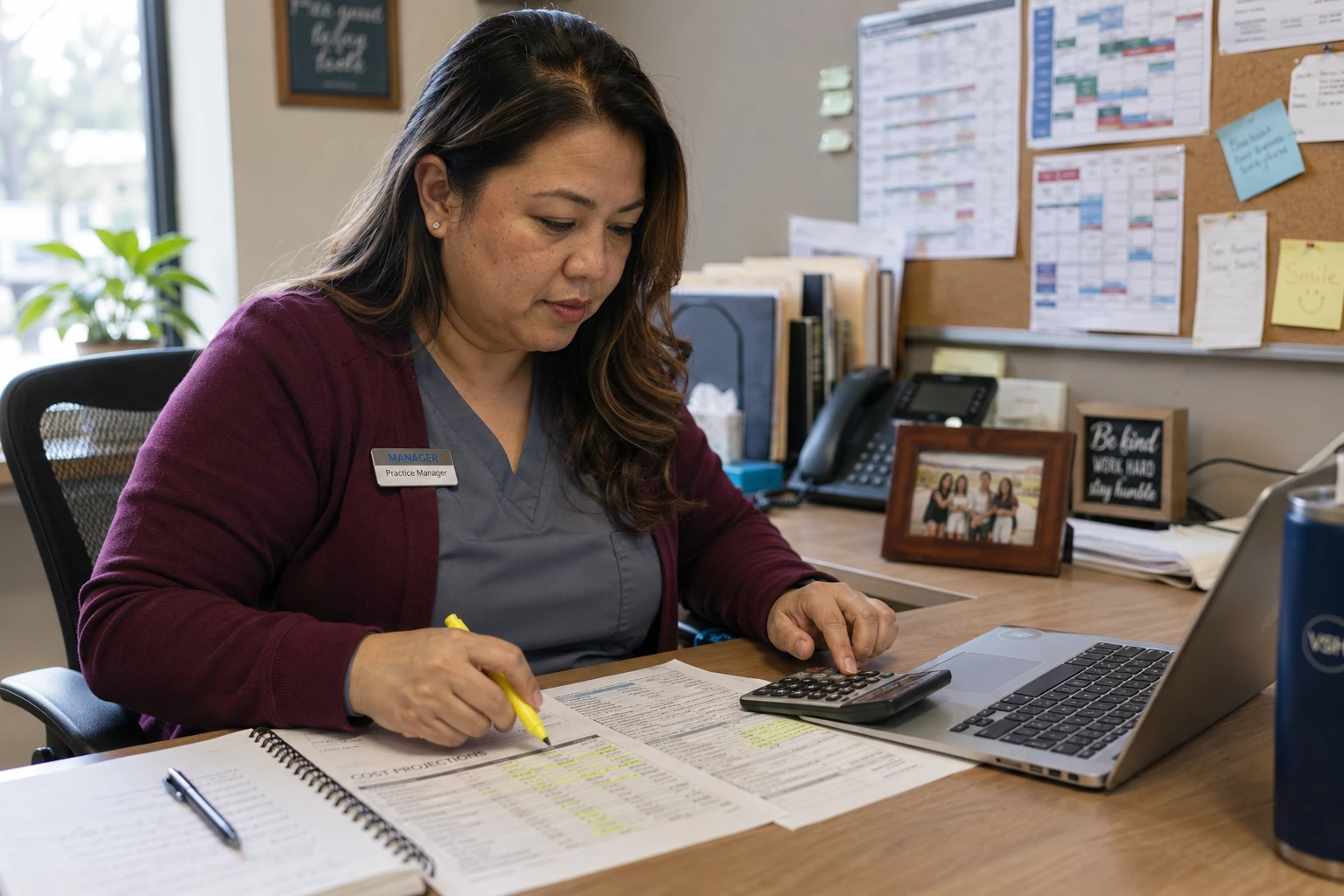 Practice manager working through a five-year veterinary software cost of ownership model at her office desk