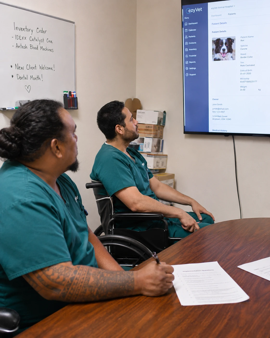 Veterinary team running a structured vendor demo of a veterinary telehealth platform in a clinic meeting room